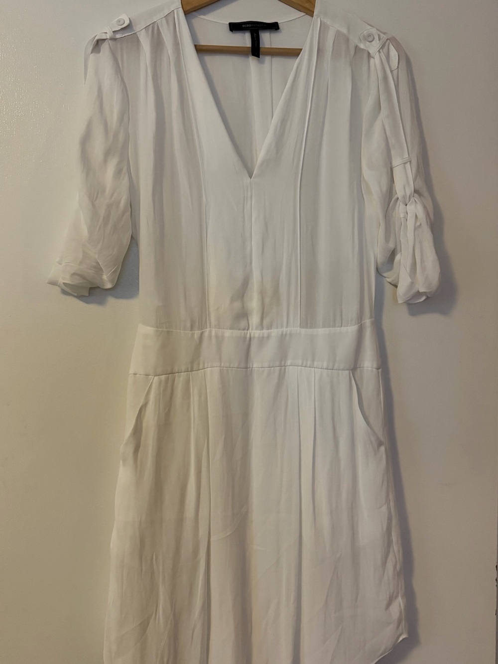 BCBG white dress with pockets and rolled sleeves.